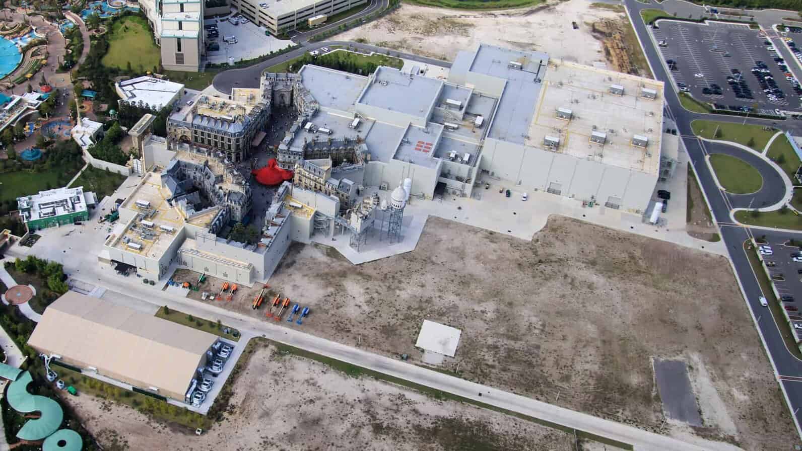Aerial view of dirt expansion area near Harry Potter-themed land at Epic Universe
