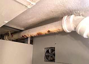 Old cast iron corroded leaky drain pipe