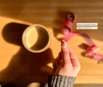 A hand holding a ring.