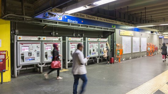 People using metro ticket machines at Rome’s underground station.