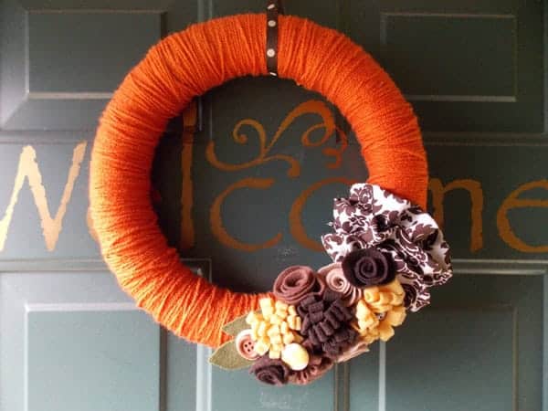 DIY fall wreath with colorful autumn leaves and pinecones