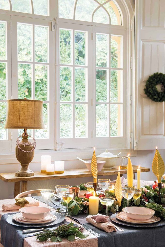 1. A TABLE RUNNER WITH GREENERY, NATURAL FRUITS, AND CANDLES