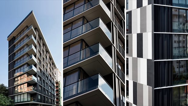 Modern high-rise residential building with sleek glass balconies and contemporary architectural design, highlighting urban apartment living.