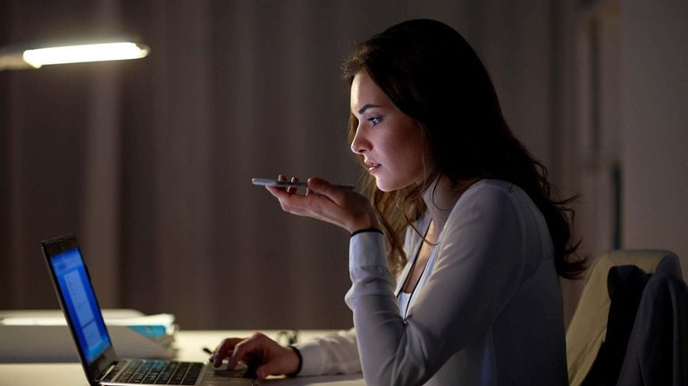 Cropped woman using voice command recorder on smartphone.jpg