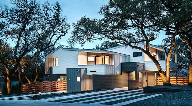 Modern contemporary house with sleek architectural design and innovative angles, surrounded by mature trees and landscaped yard, showcasing stylish home architecture and urban design.