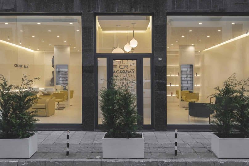 Modern commercial interior design featuring a minimalist color palette, sleek furniture, and contemporary lighting fixtures in a stylish, inviting space.