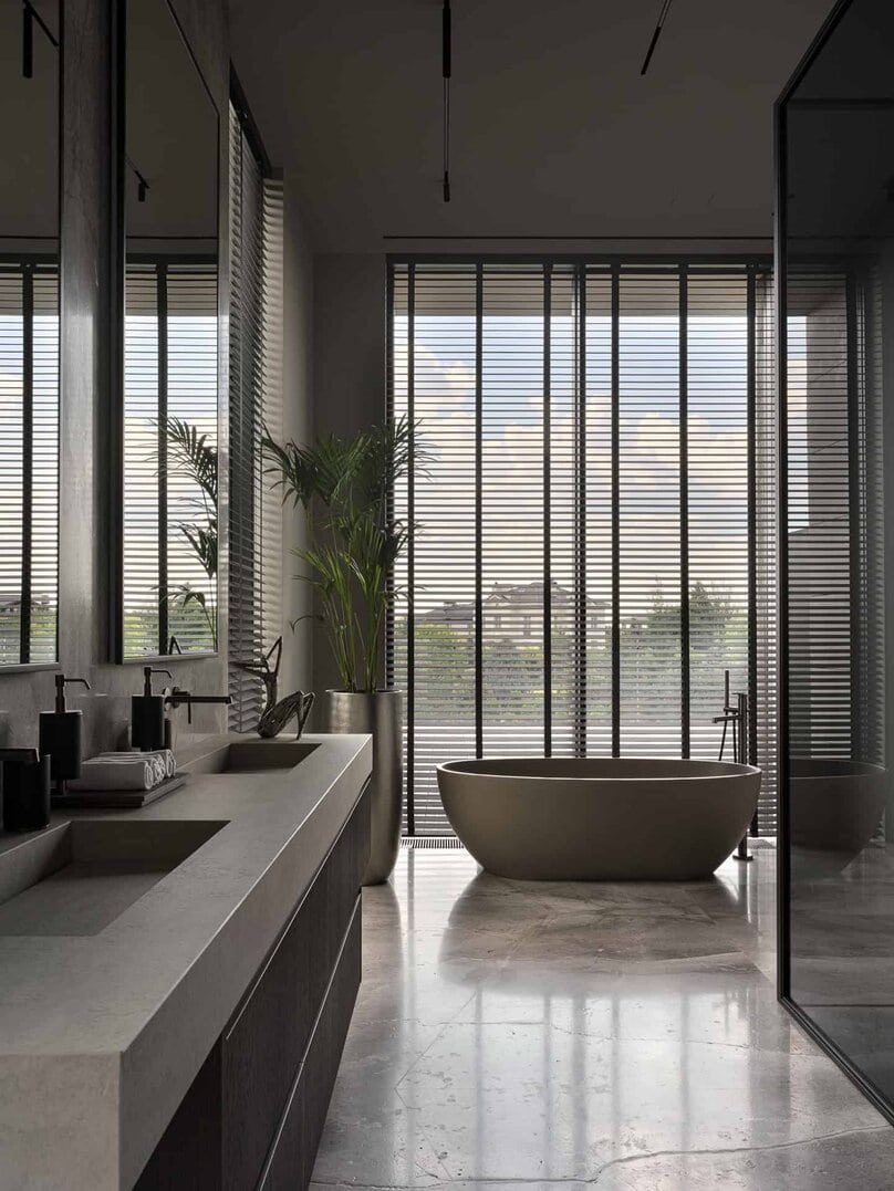 Spacious bathroom with floating vanity and ample natural light from floor-to-ceiling windows.