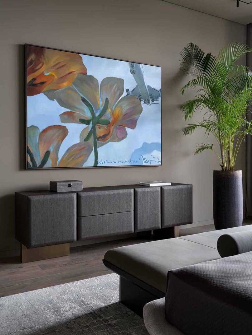 Contemporary bedroom featuring a media console and a vibrant floral painting.