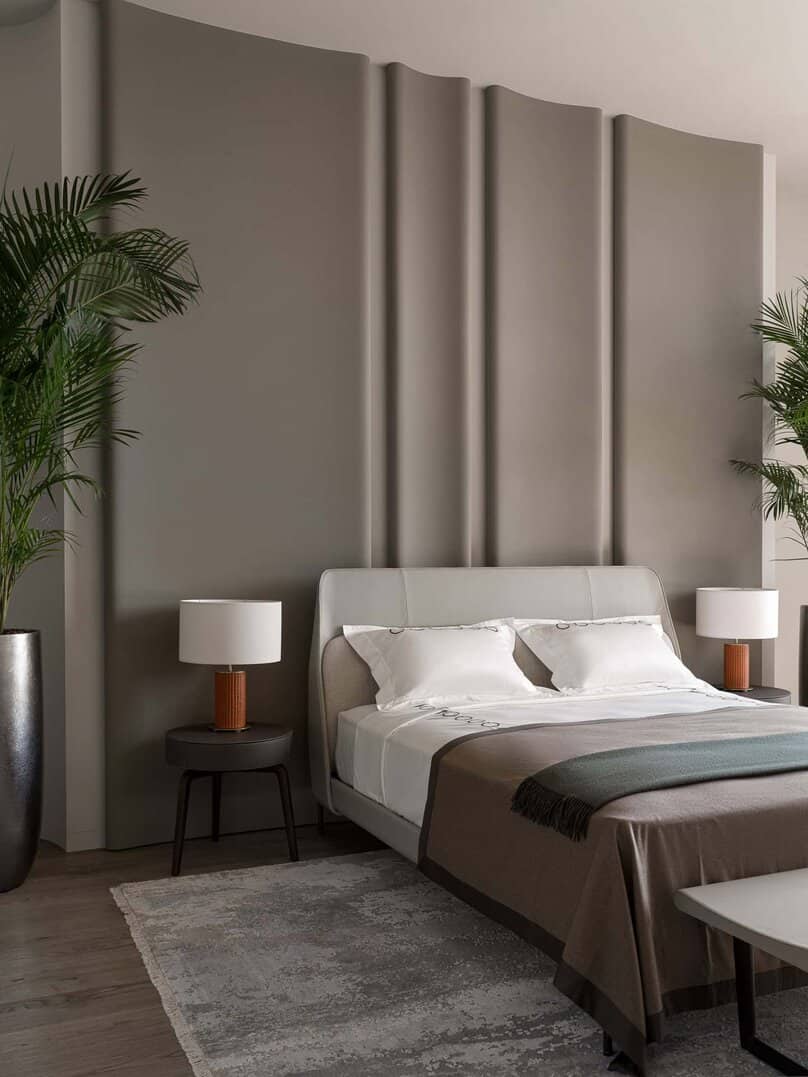 Elegant bedroom featuring a soft curved-panel headboard design.