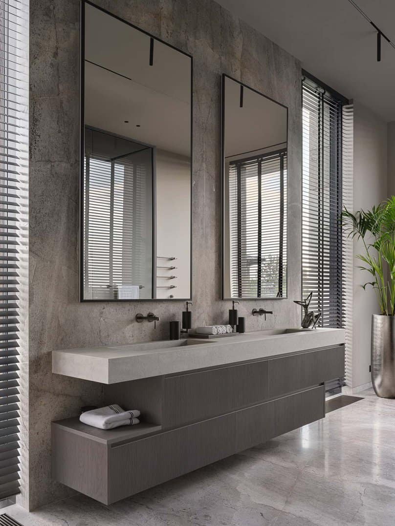 Dual vanity with large mirrors and minimalist design in a modern bathroom.