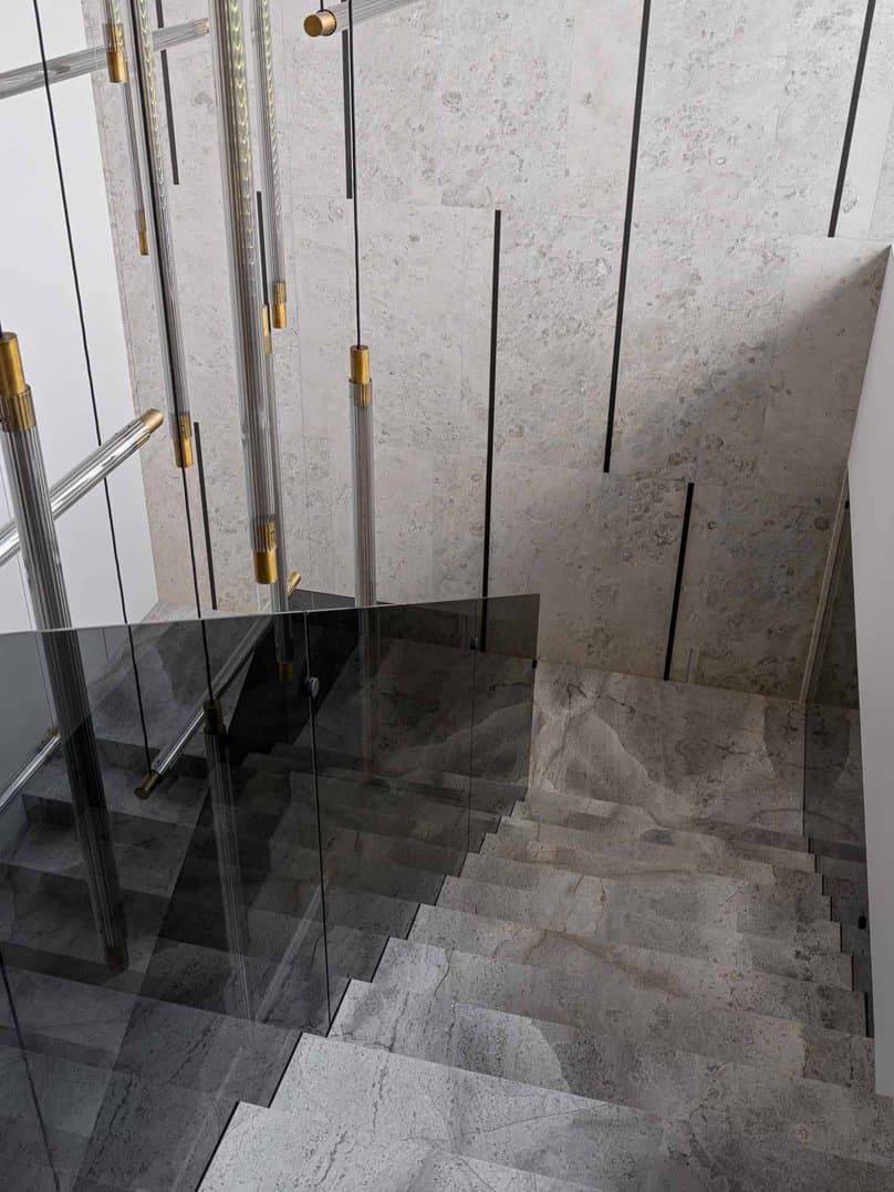 Elegant staircase with limestone treads and transparent glass handrail.