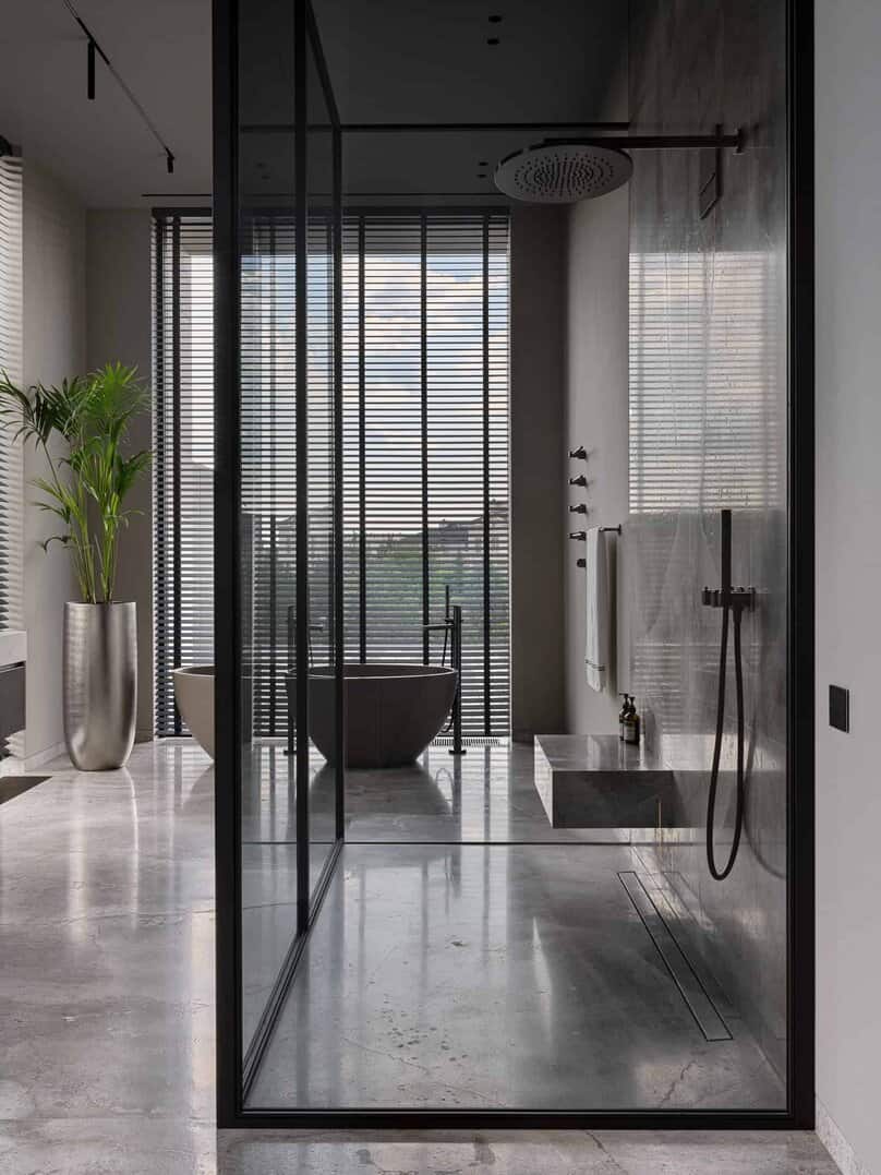 Luxurious bathroom with glass-enclosed shower and a freestanding soaking tub.