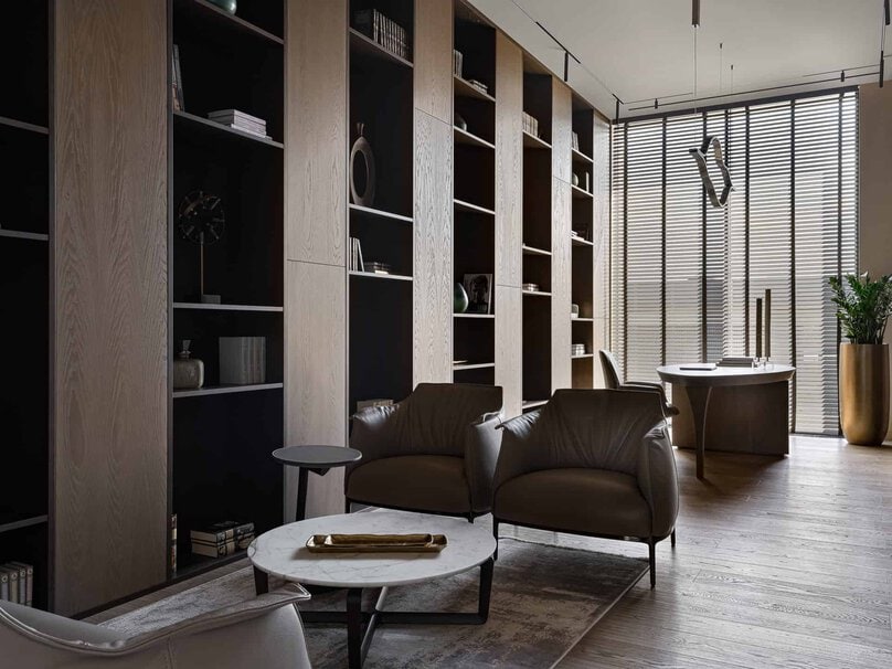 Sophisticated library interior with tall bookshelves and natural light.