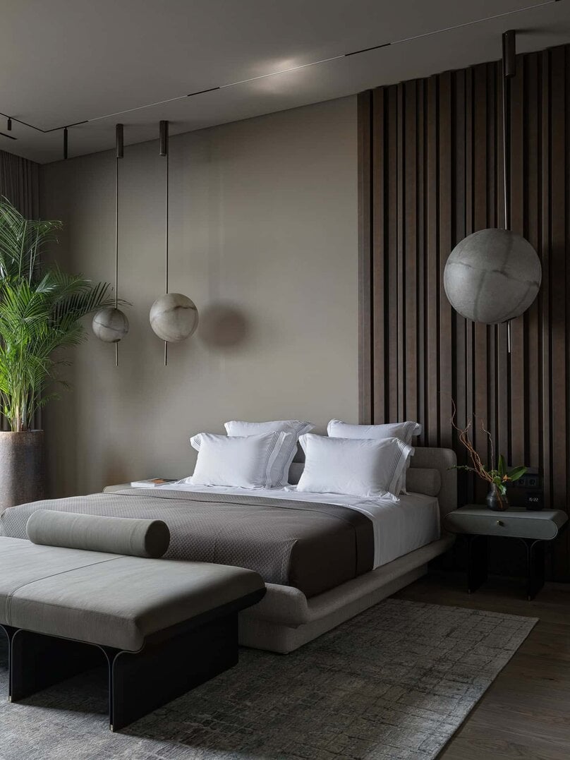 Spacious modern bedroom with outdoor access and full-height windows.
