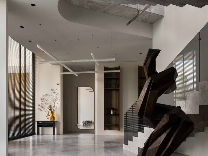 Striking geometric sculpture on staircase in modern minimalist interior.