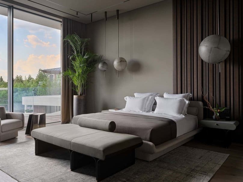 Serene bedroom design with spherical pendant lights and neutral tones.