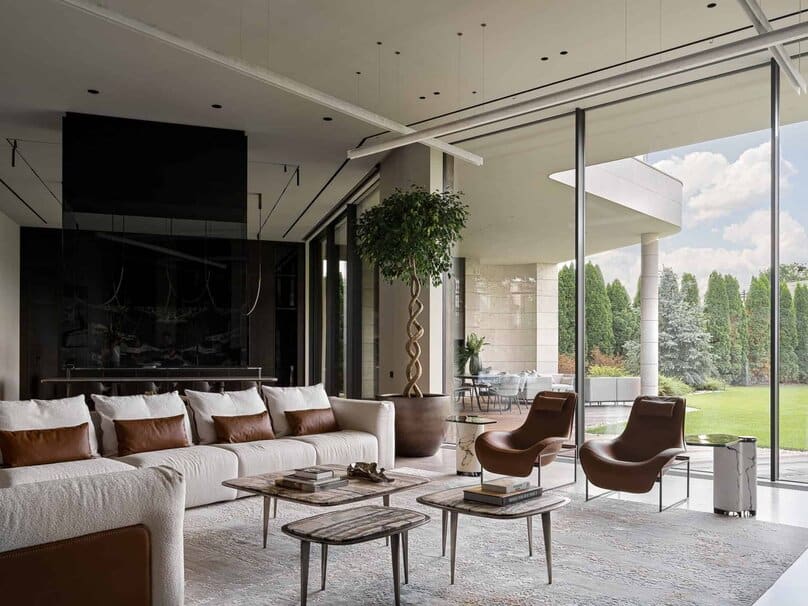Open-plan living area with modern furniture and seamless connection to garden.