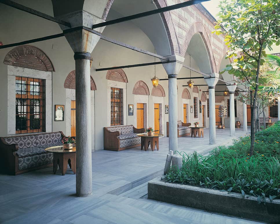 View of the historic Hürrem Sultan Hamam, built by Mimar Sinan, with the iconic domes and minarets of Hagia Sophia in the backdrop.