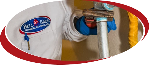 A Bell Brothers technician, dressed in a professional uniform and protective blue gloves, skillfully handles a metal pipe beside a yellow flexible hose. With our trusted team of background-checked experts, upfront pricing, and our No Surprise Guarantee, we're proud to deliver reliable plumbing service to homes throughout Northern California.