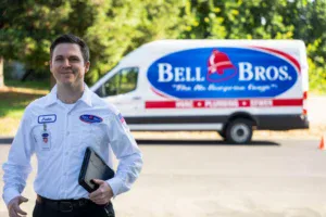 A trusted, background-checked Bell Bros. technician stands in Sacramento, ready to serve with upfront pricing and a No Surprise Guarantee.