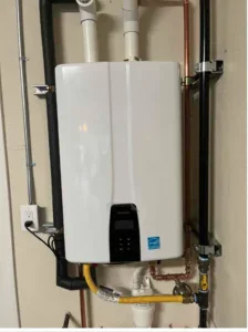 A tankless water heater is securely wall-mounted with pipes and wiring, expertly installed by Bell Brothers’ trusted technicians.
