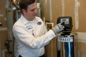 A background-checked Bell Brothers tech adjusts a HALO water system, delivering trusted service with upfront pricing and no surprises.