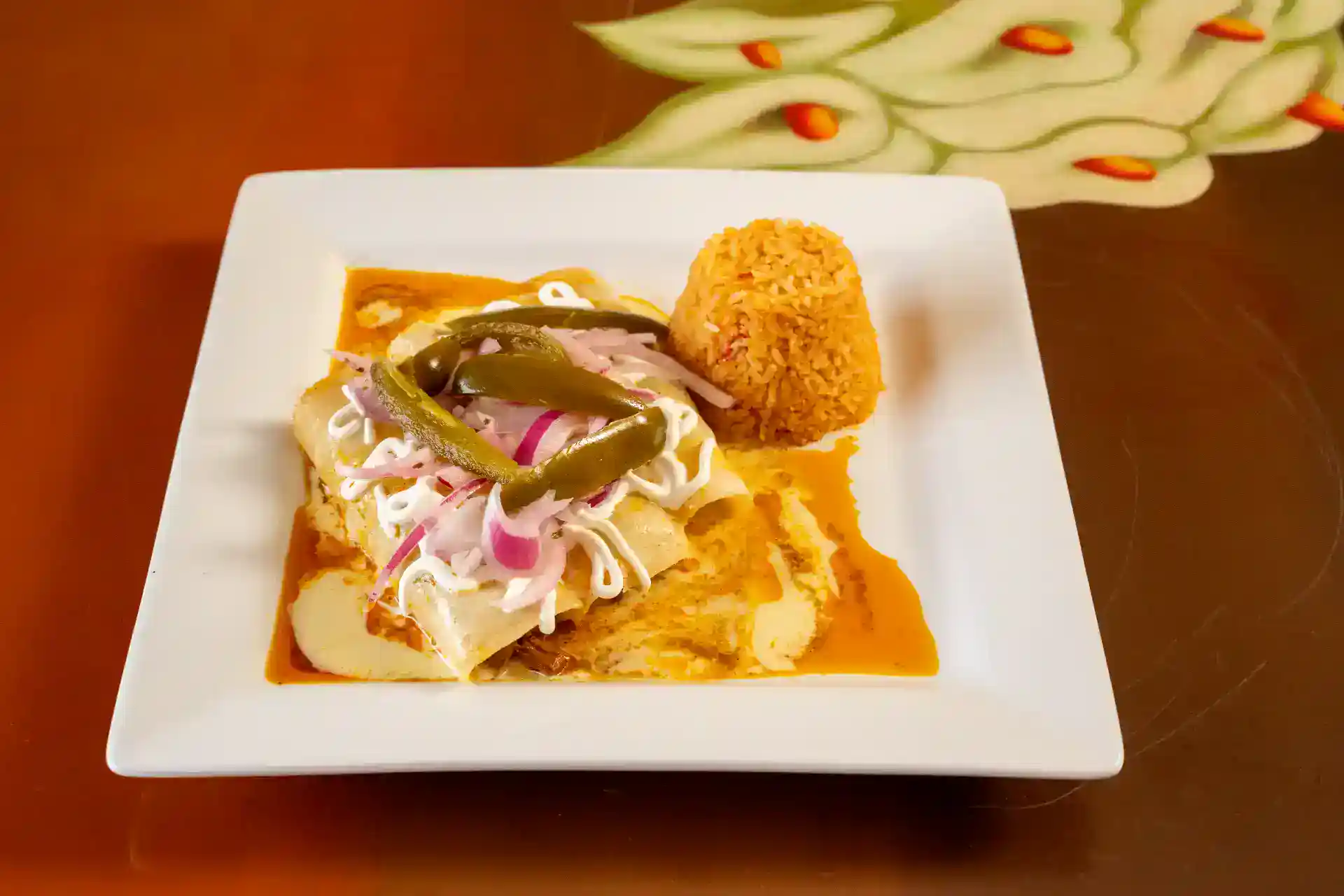 Delicious Mexican taco served with rice, beans, shredded chicken, pickled onions, and jalapeños on a