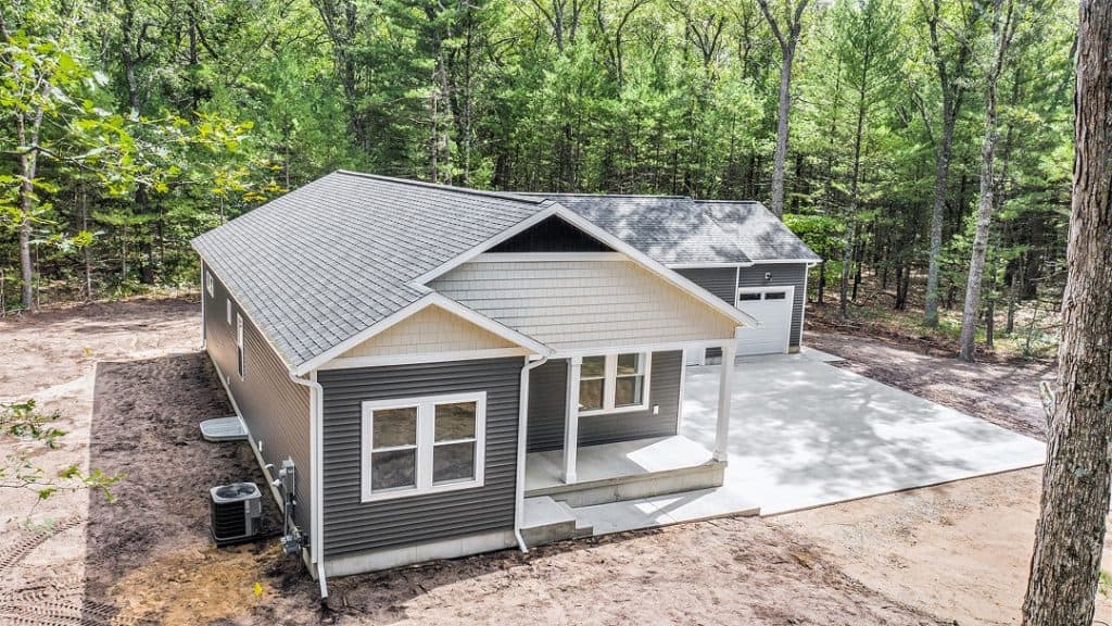 Modern house built by BuildWest Custom Homes in a wooded area.