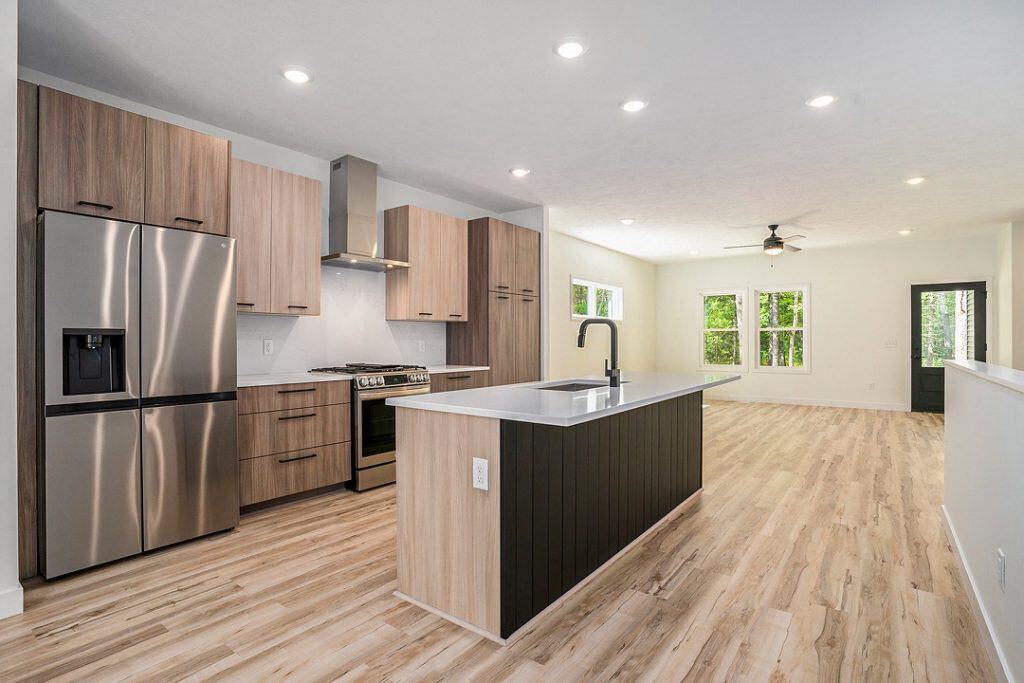 Spacious modern kitchen with stainless steel appliances and island.