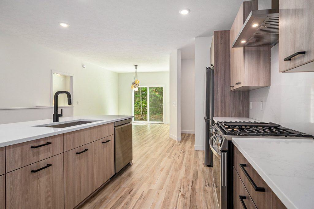 Contemporary kitchen with wood cabinets and stainless steel appliances.