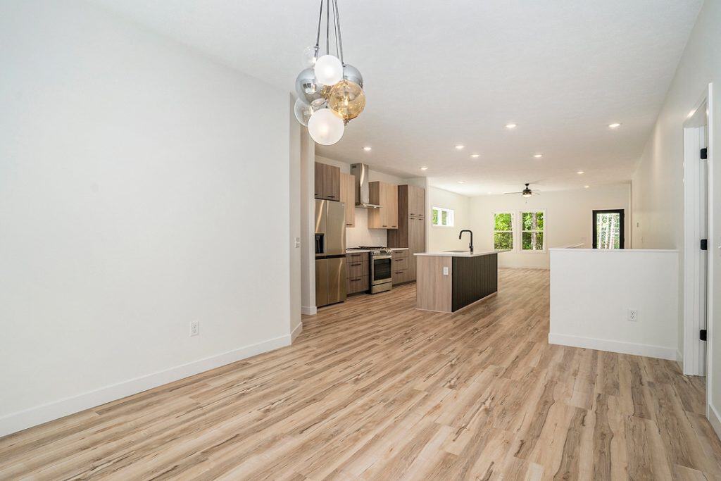 Spacious modern kitchen with island and open living space in a new build home.