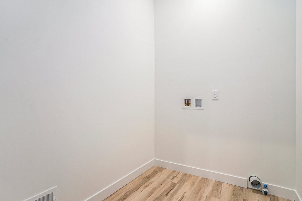 Empty interior wall with electrical outlets in a new home.