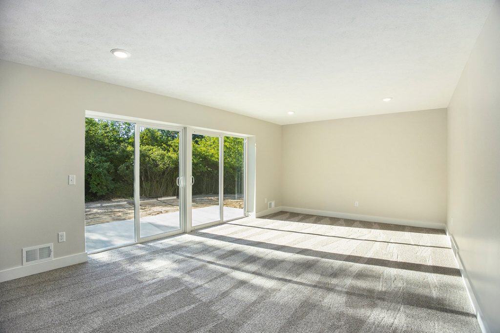 Spacious living room with large sliding glass doors and natural light.