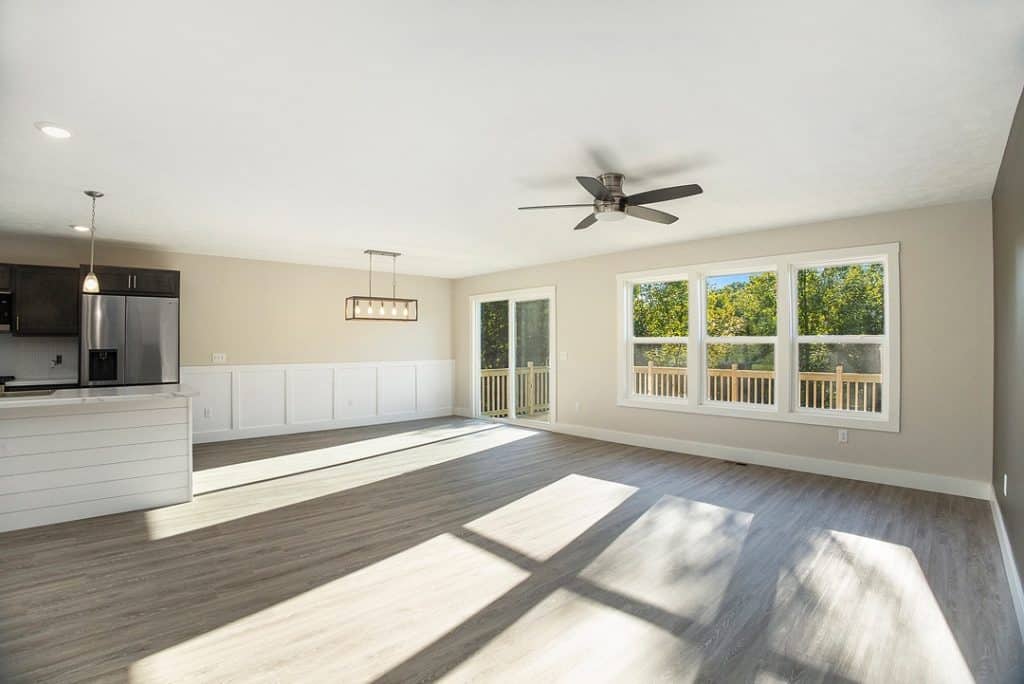 Bright open living room with large windows and hardwood floors.