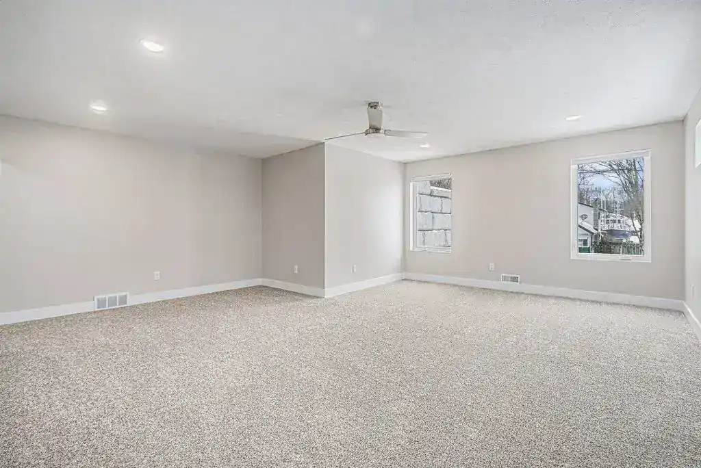 Bright, spacious living room with large windows and neutral decor.