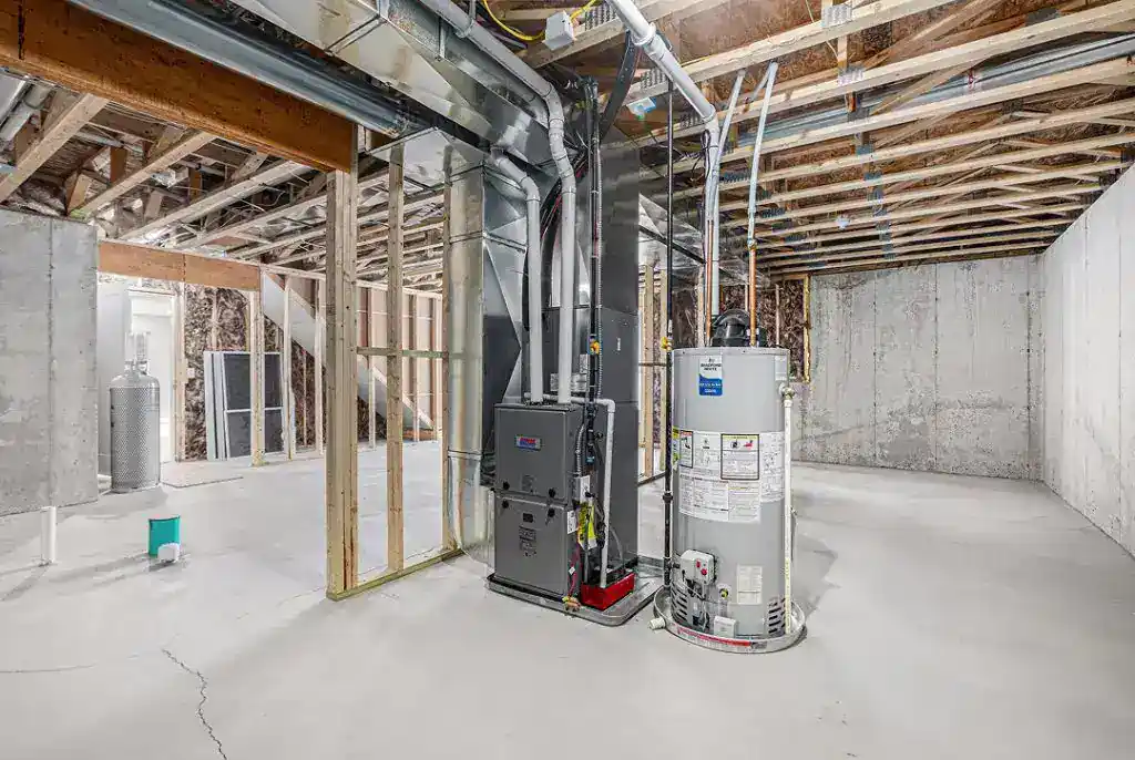 Construction site utility room with HVAC and water heater systems.