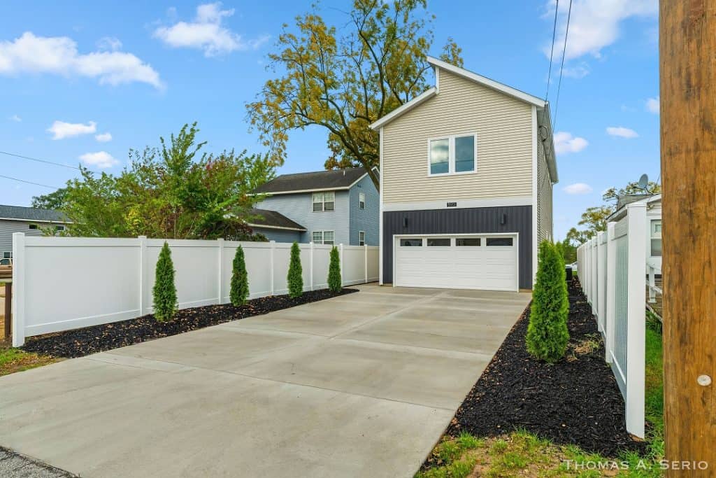 Contemporary two-story home with garage and landscaped yard.