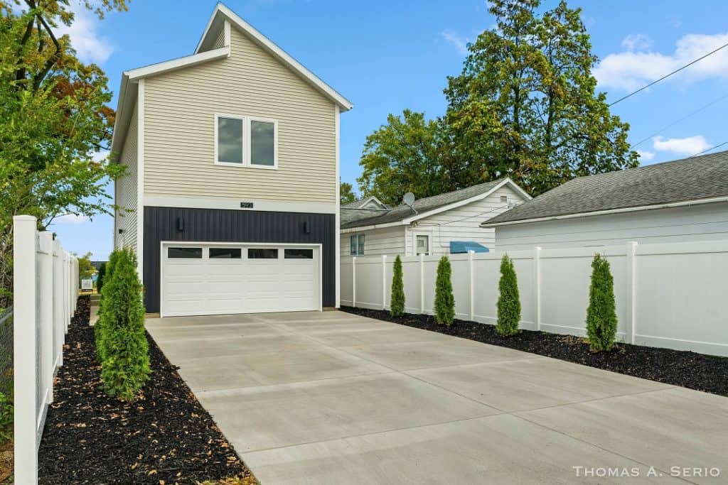 Contemporary two-story home with an elevated garage and landscaped driveway.