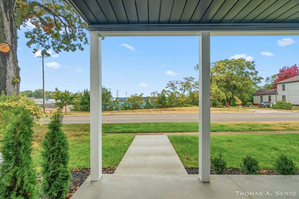 View from porch showing front yard and neighborhood scenery.