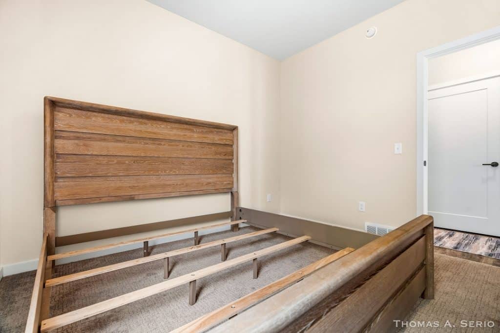 Wooden bed frame in a new bedroom under construction.