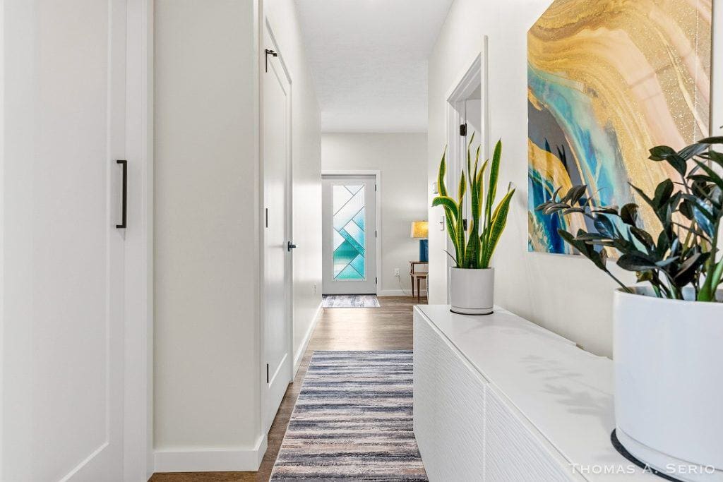 Bright and welcoming home entryway with modern decor and plants.