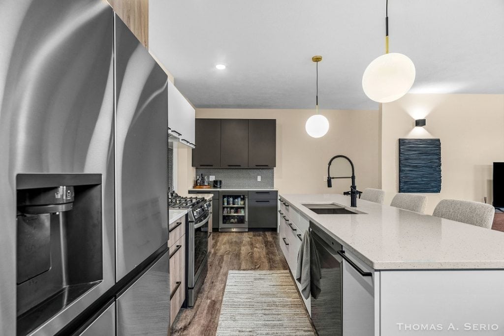 Contemporary kitchen with stainless steel appliances and minimalist decor.