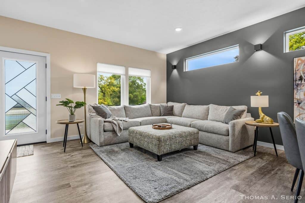 Spacious modern living room with large sectional sofa and natural light.