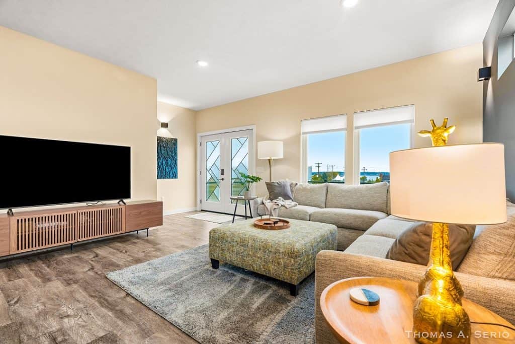 Bright and spacious living room with large windows and contemporary furniture.