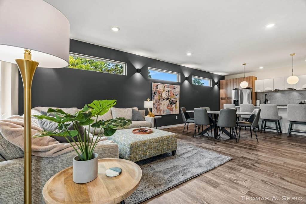 Spacious modern living room with stylish furniture and large windows.