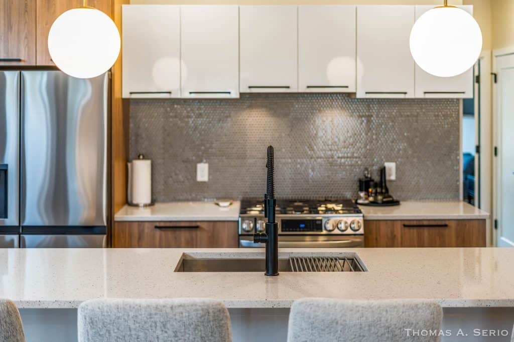 Contemporary kitchen with sleek cabinetry, island, and modern appliances.