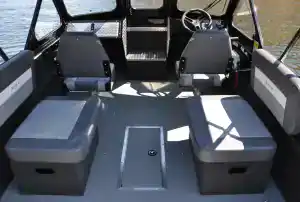 Boat interior with seating and steering wheel for Thunder Jet 205 Rush.