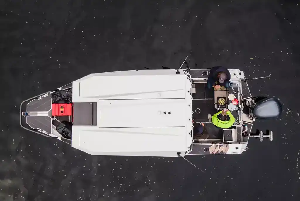 Aerial view of the StabiCraft 2250 UltraCab boat on water with two people onboard.