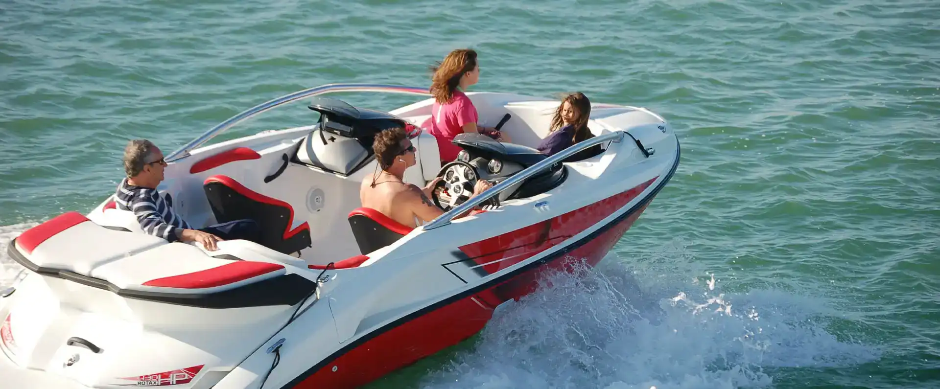 Family enjoying a ride on a luxury speedboat on the water.