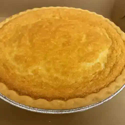Buttermilk Pie in a foil pan, showcasing a golden-brown, flaky crust and creamy filling, perfect for dessert or special occasions.